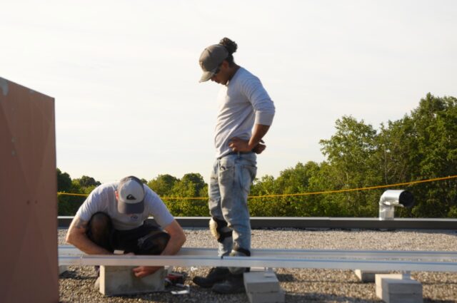 Installers preparing the racking for the solar arrays